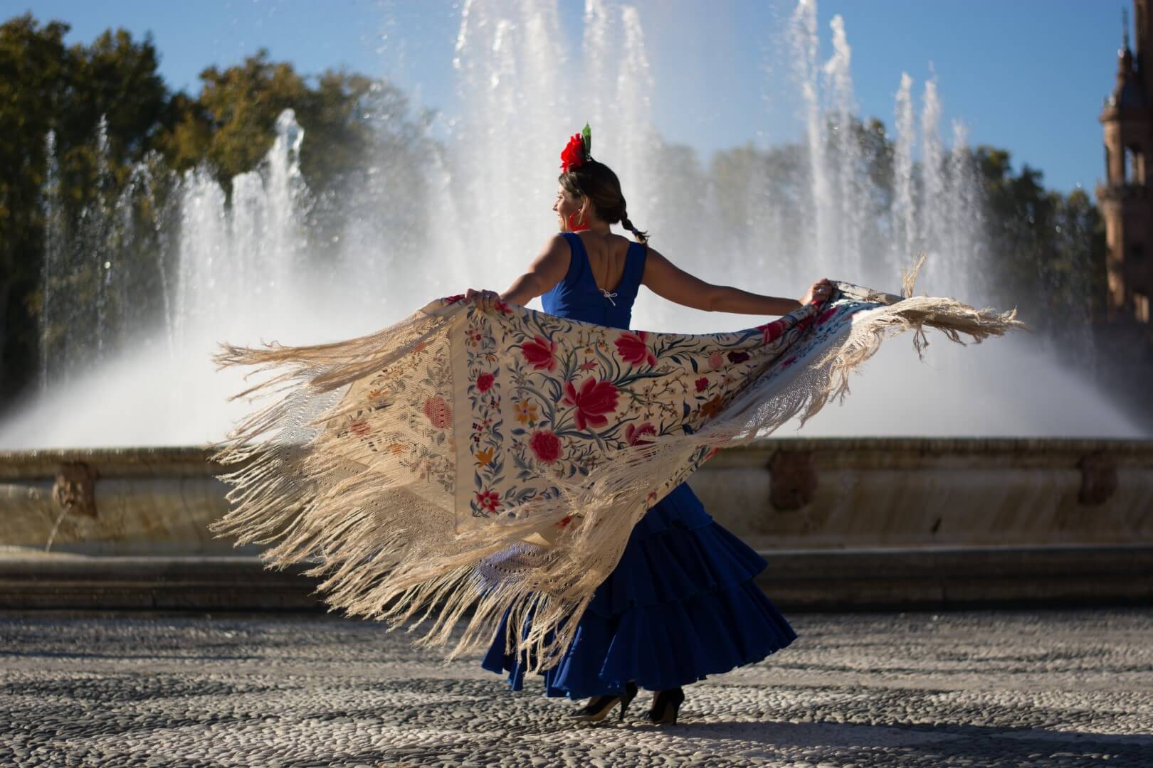 sevillana bailando delante de una fuente por el día internacional del flamenco